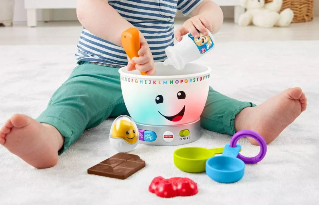 child playing with a toy mixing bowl