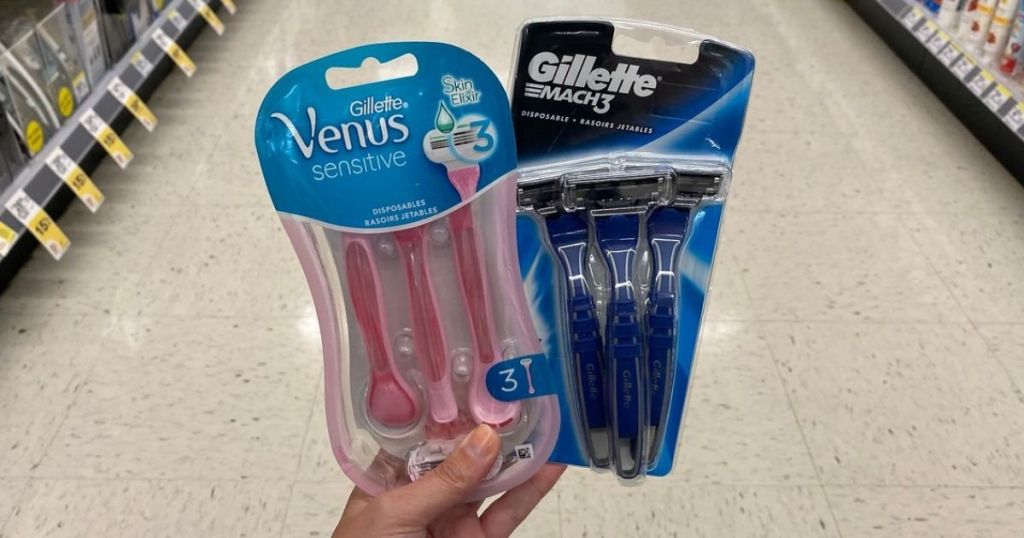 woman's hand holding Venus and Gillette Disposable razors