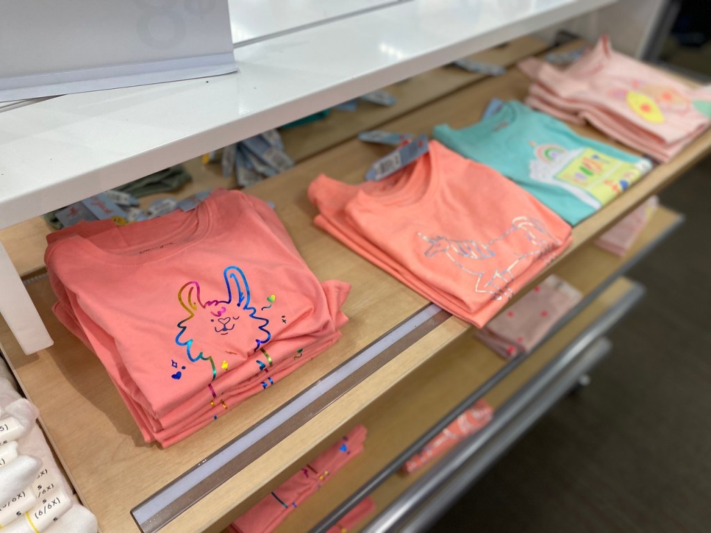 Girls Graphic Tees on display table in store