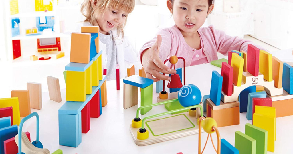 girls playing with Hape Dominos Set