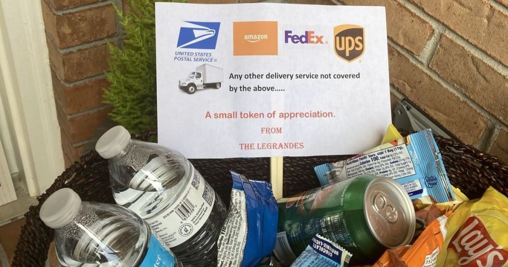 Basket filled with bottle water and snacks with sign encouraging delivery drivers to take some