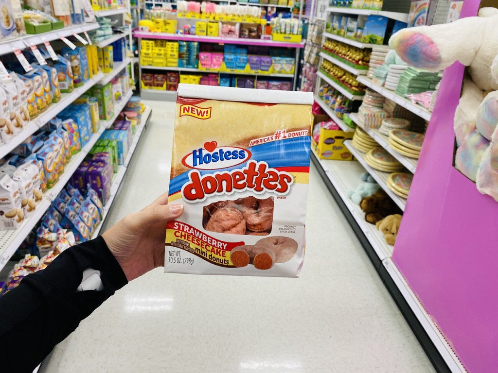 wioman holding up Hostess Donettes