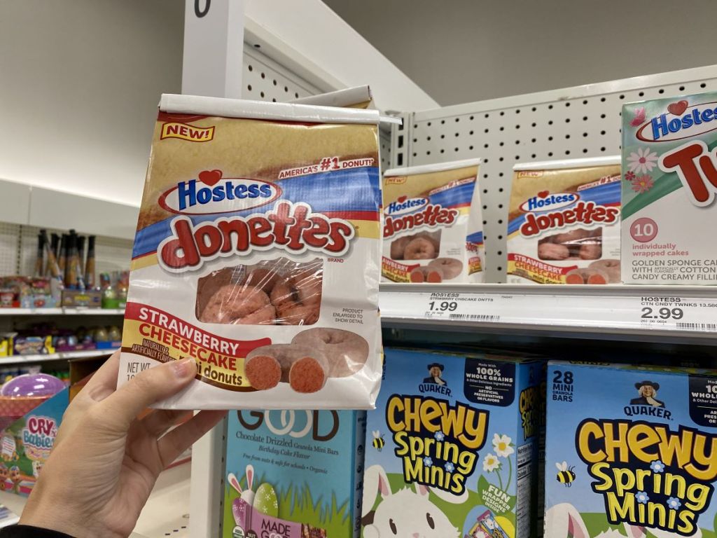 hand holding a bag of Hostess Donettes