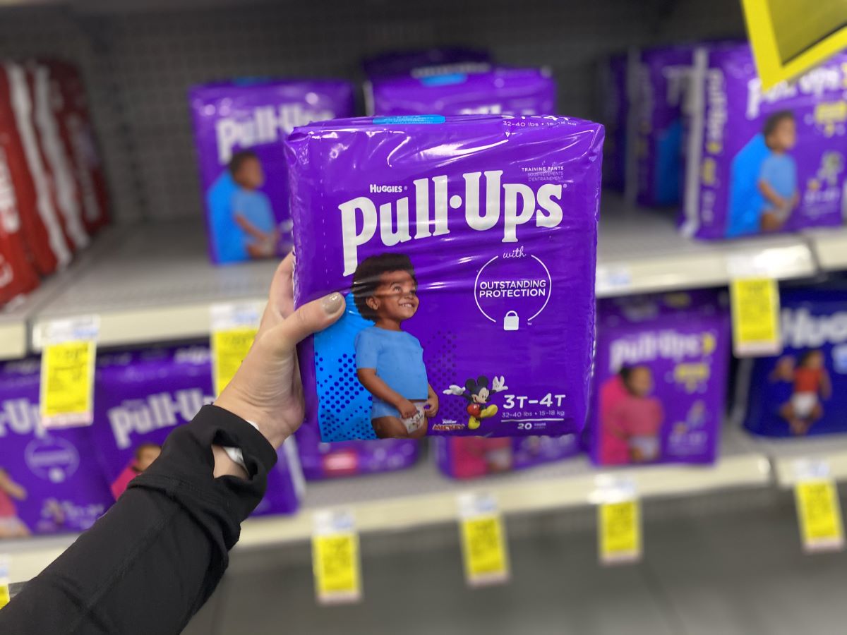 hand holding a package of Huggies Pull-Ups