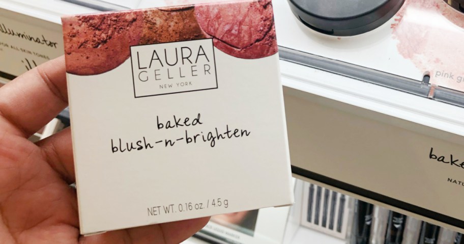 Laura Geller brand blush in package near in-store display of testers