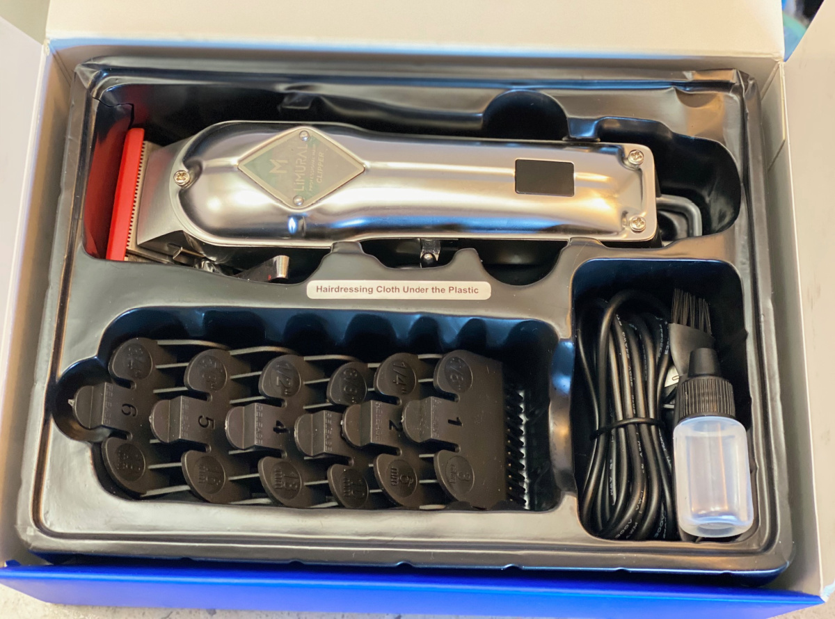 Professional hair clippers set in package with attachments