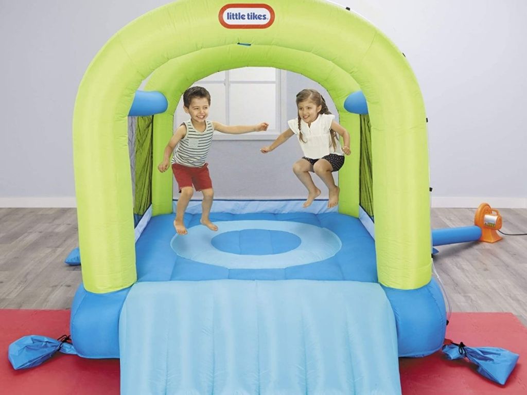 two kids jumping in Little Tikes Splash & Spray Bounce House