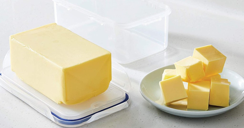 plate of butter chunks and butter in food storage container with lid