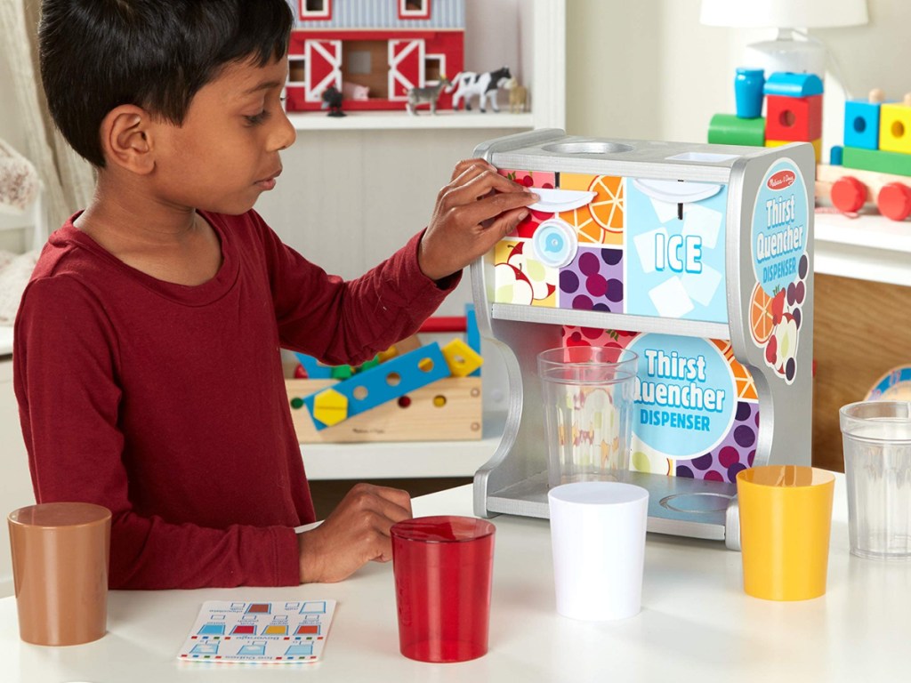 little boy playing with a melissa and doug thirst quencher