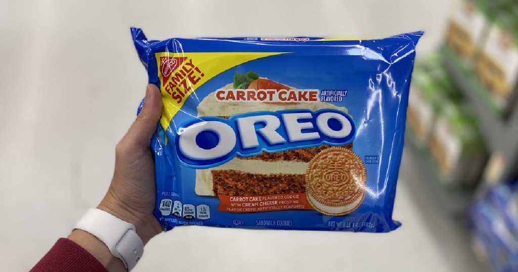 Hand holding up a pack of Nabisco Carrot Cake Oreo