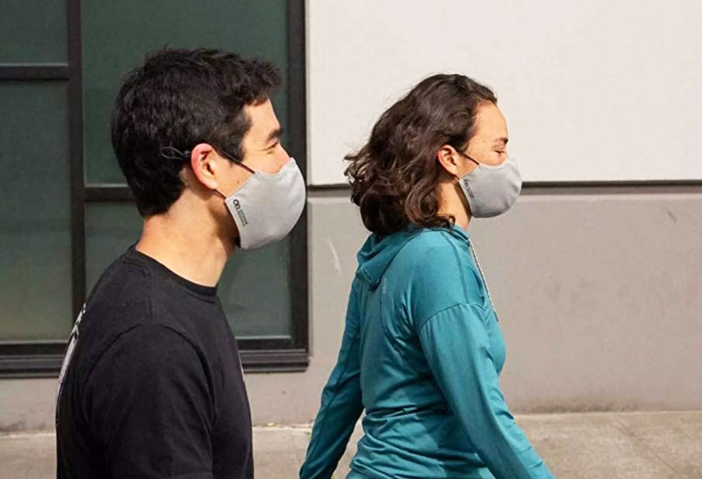 man and woman wearing grey face masks
