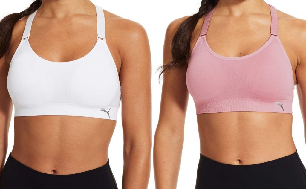 woman in white sports bra and woman in pink sports bra