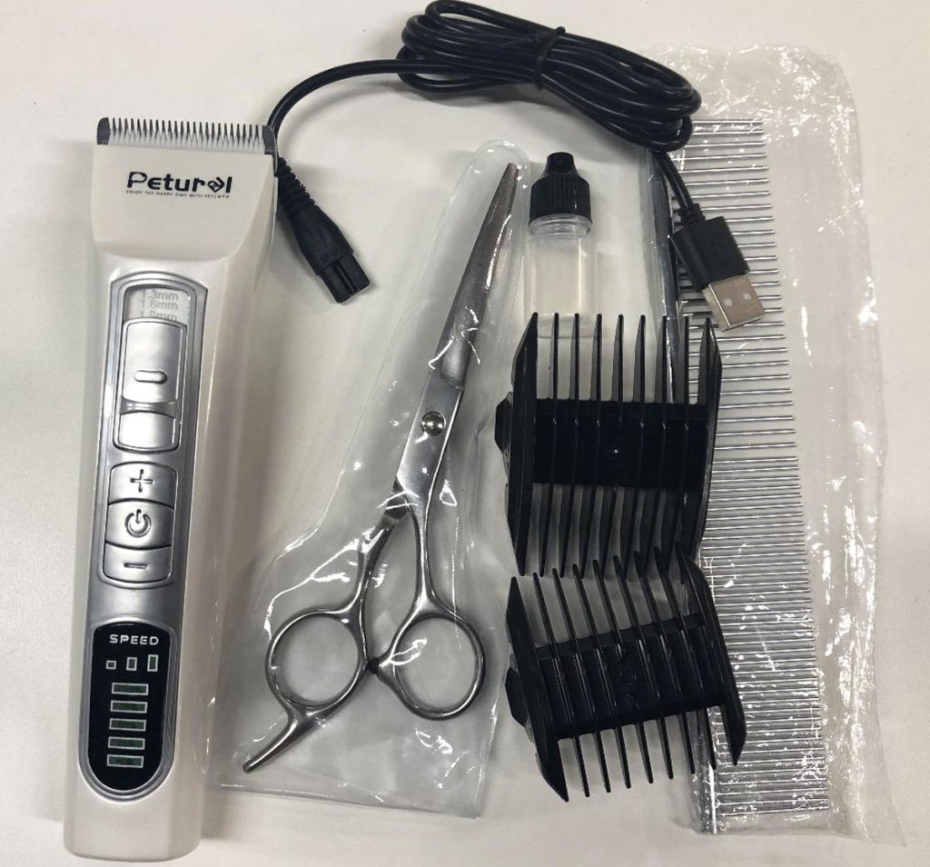 cordless dog clippers, scissors, comb, blade attachments, and charging cable
