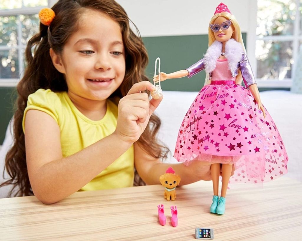 girl playing with Princess Barbie Playset