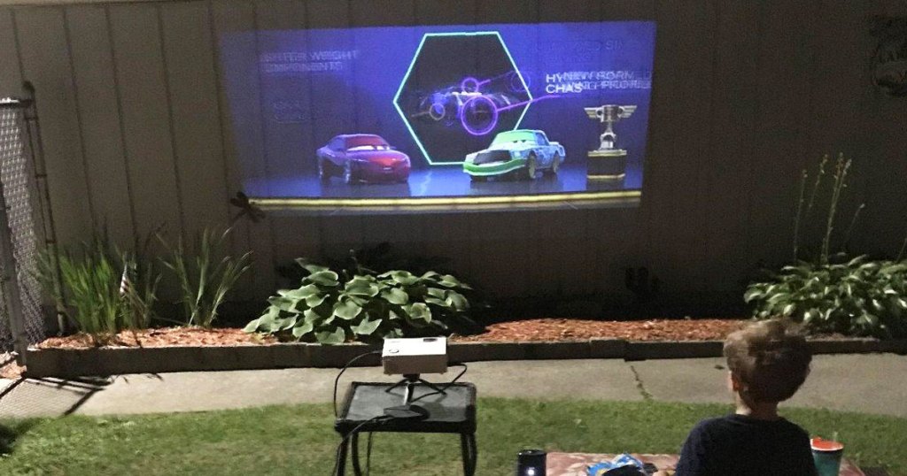 movie projector showing movie on side of house