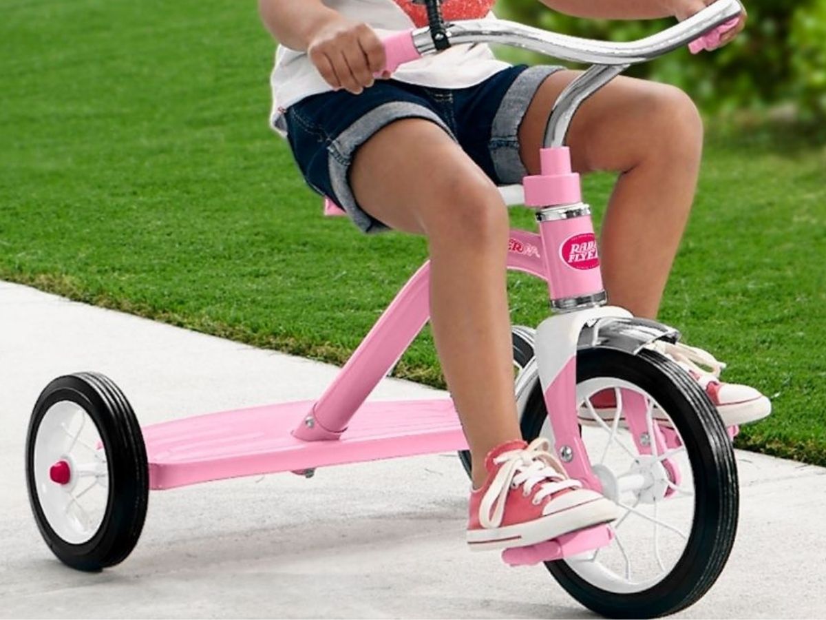 Little girl on radio flyer pink tricycle