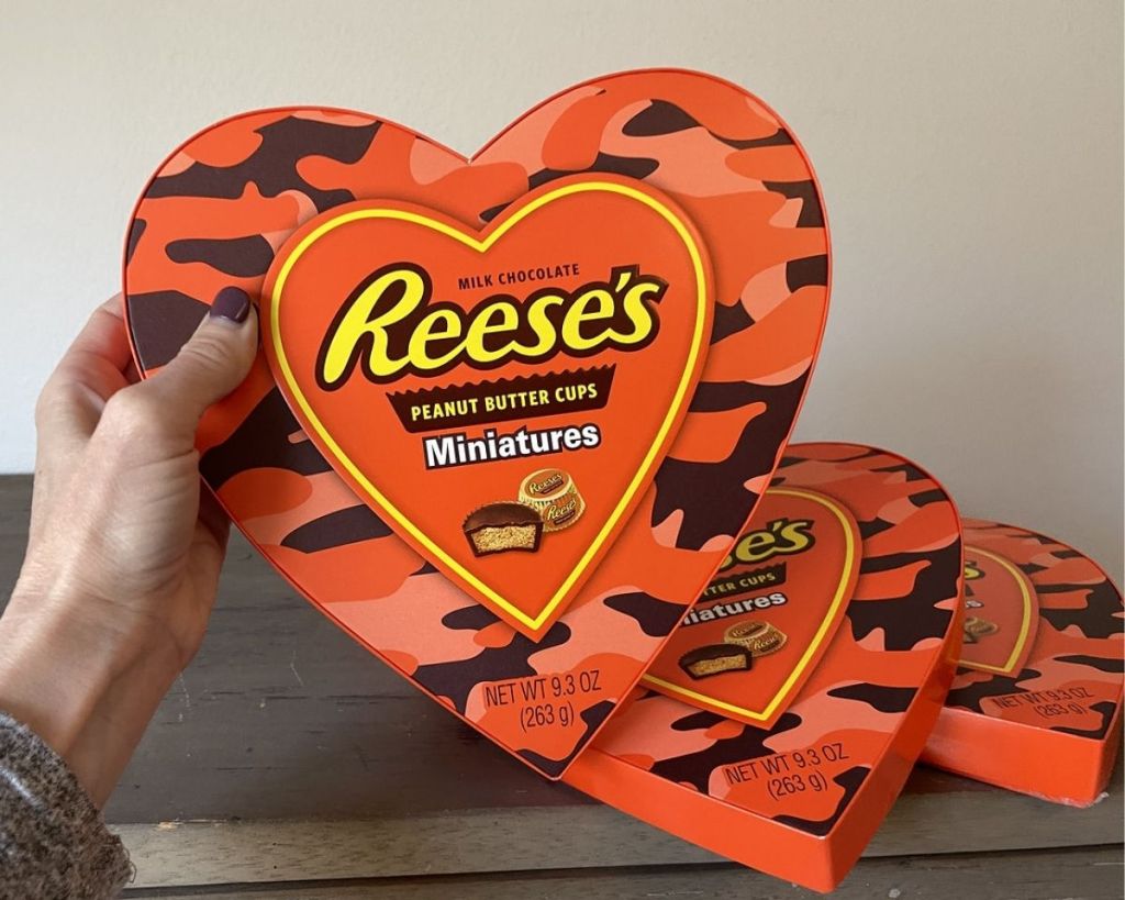 hand holding Reeses heart box with extra boxes 