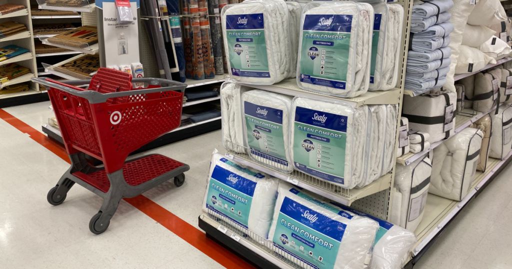 white mattress pads and blankets on shelf 