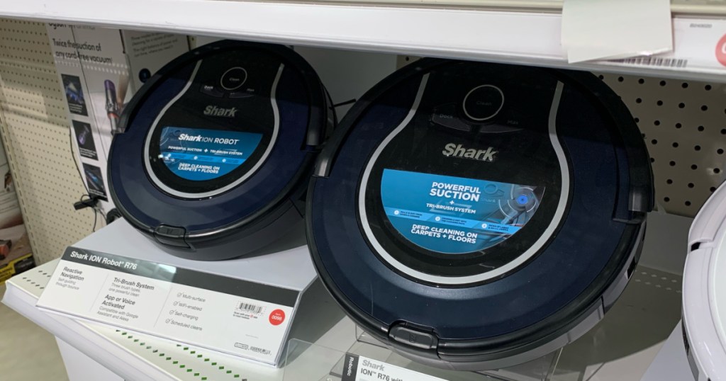two blue robot vacuums on shelf