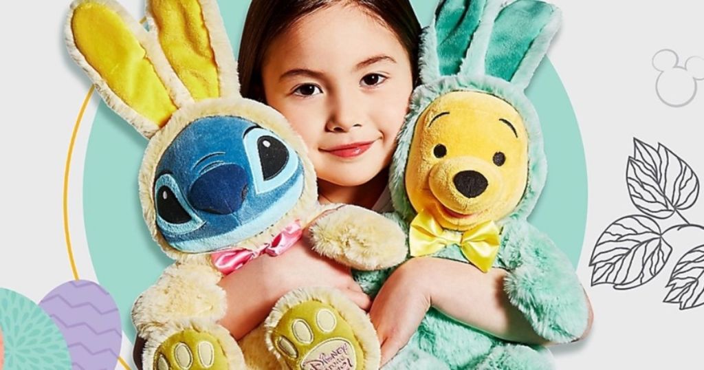 Little girl holding Easter Stitch and Winnie The Pooh