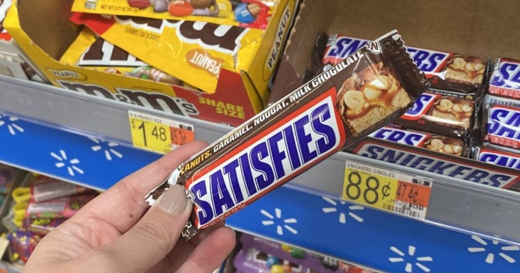 hand holding snickers in store