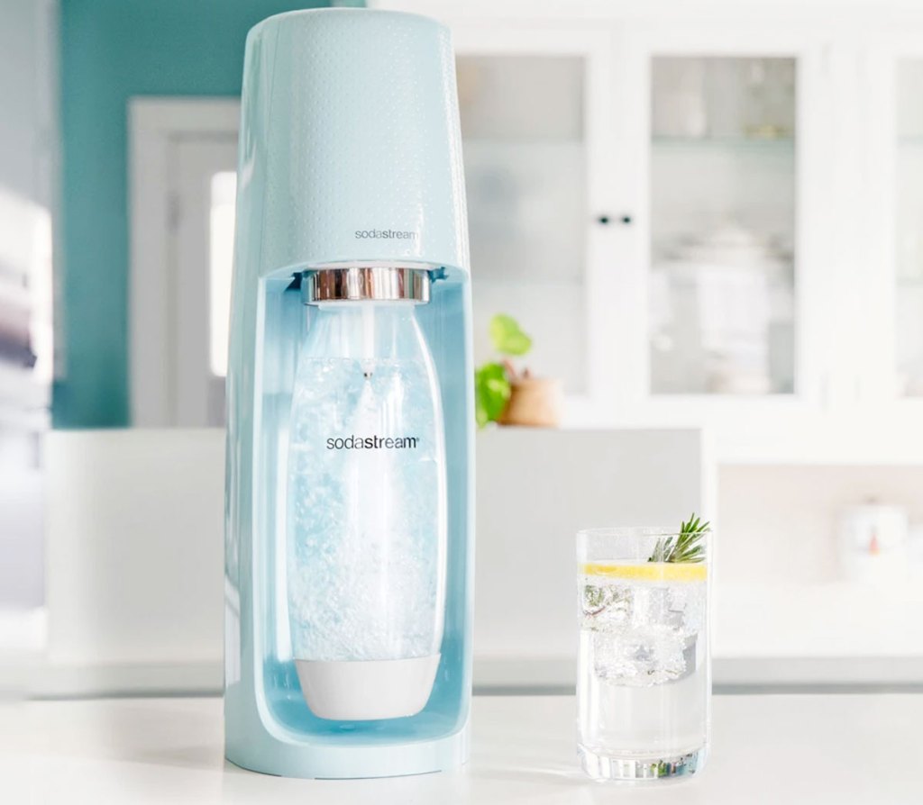 light blue sodastream machine on counter making sparkling water