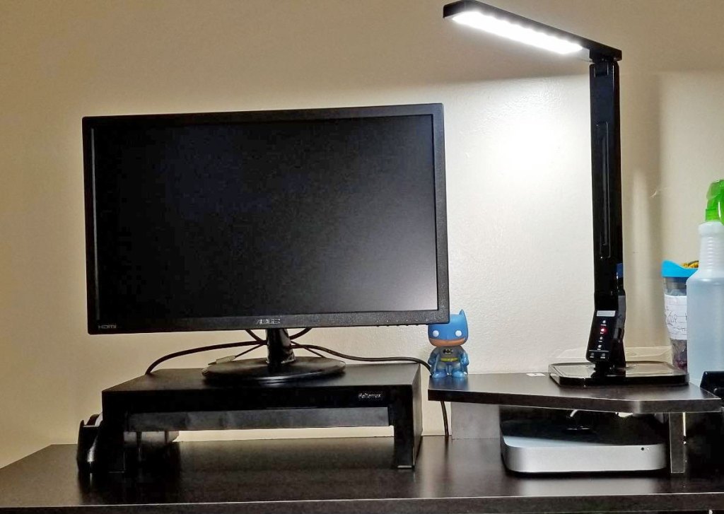 black led lamp shining over computer monitor and desk