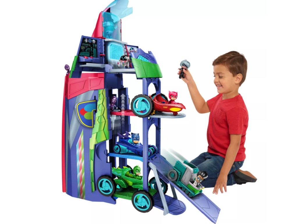 little boy playing with pj masks headquarters