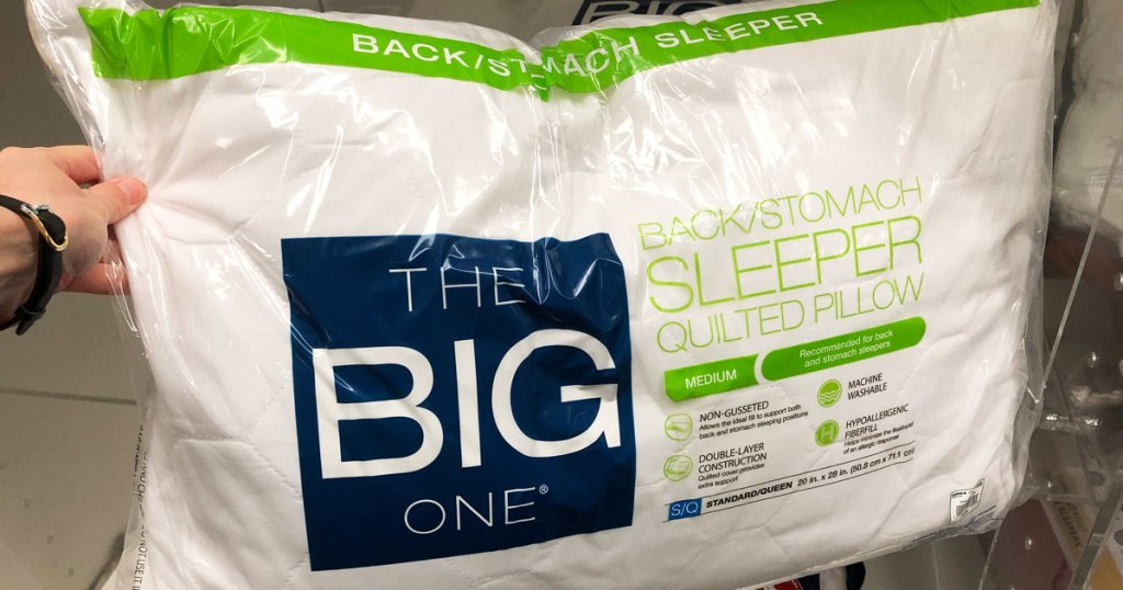 person holding the big one pillow in stores