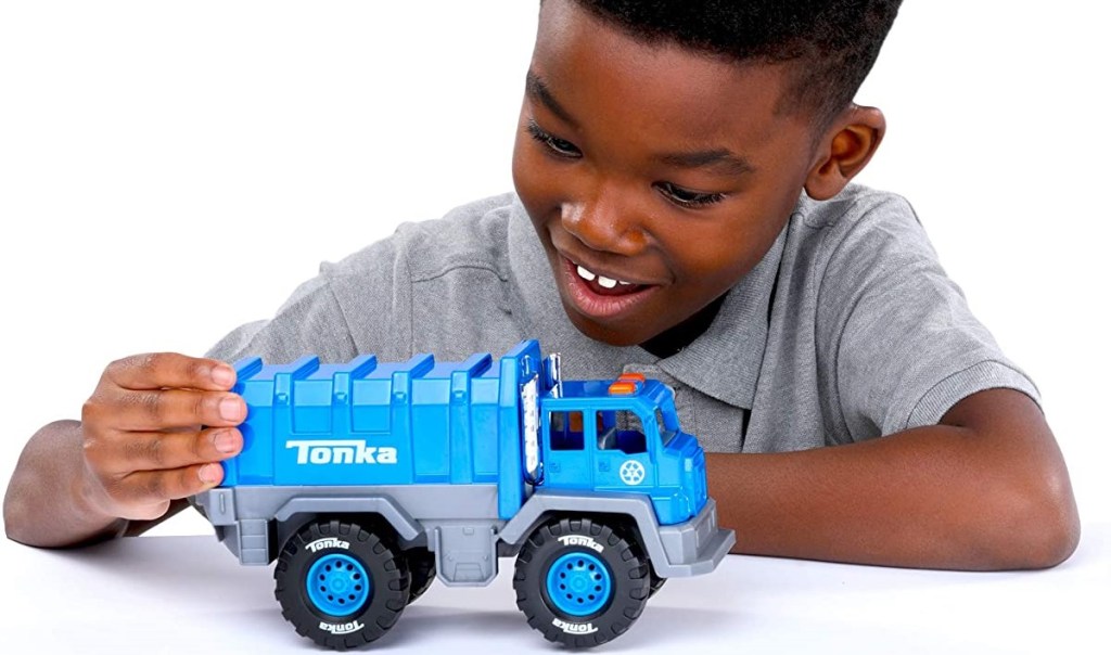 boy playing with a blue Tonka truck