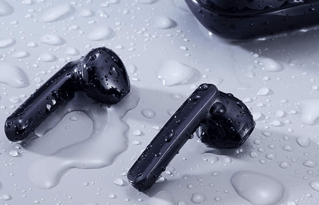 pair of earbuds with water around them