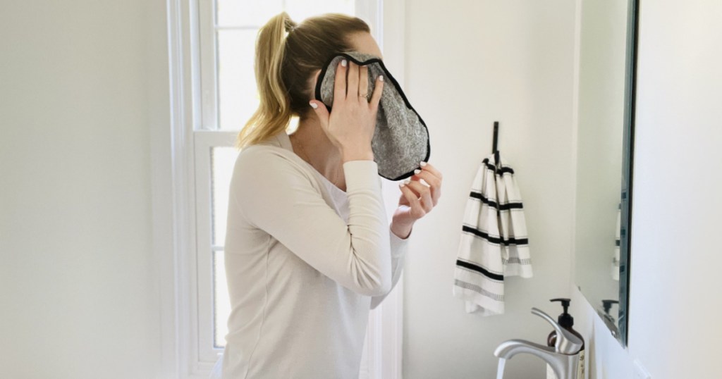 woman cleaning her face