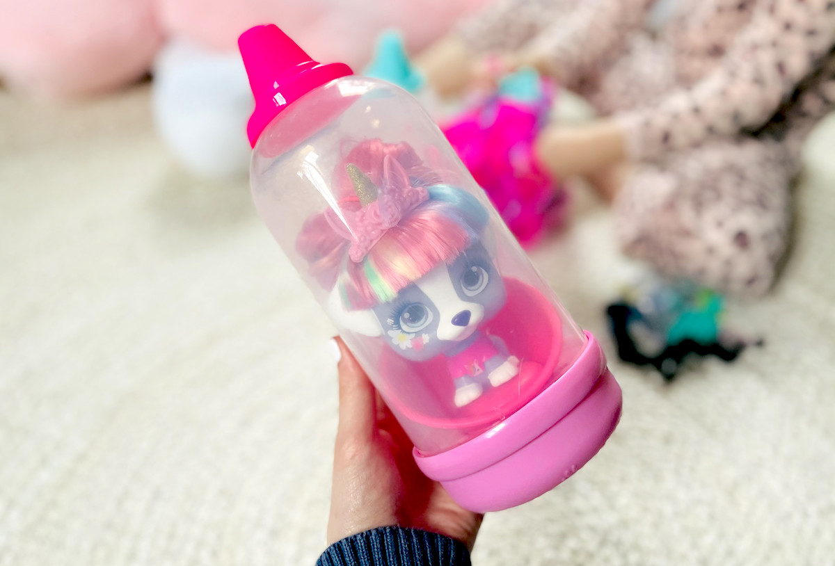 hand holding a VIP Pet doll in bottle