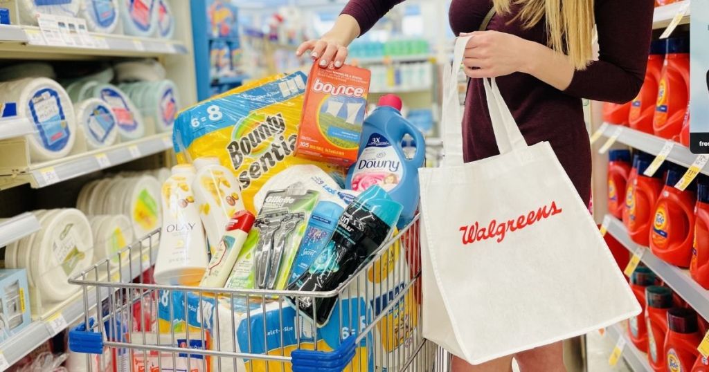woman holding a walgreens bag next to a cart