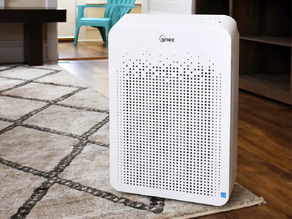 white air purifier on living room floor and carpet