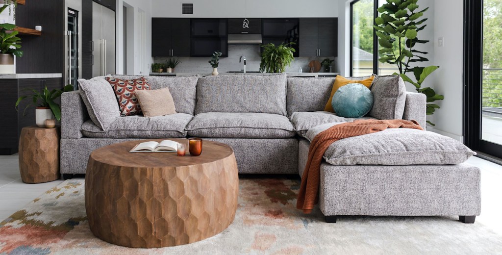 gray sectional sofa styled in living room and kitchen