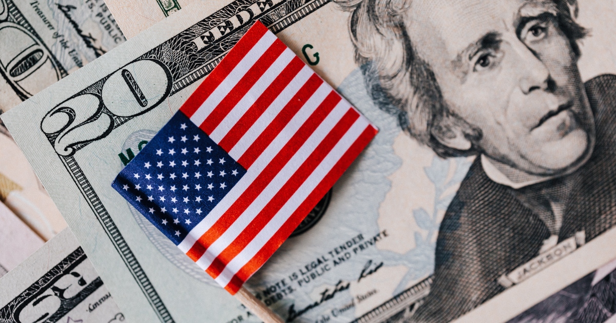 small american flag on stack of $20 bills - latest information on us treasury series I savings bond rates