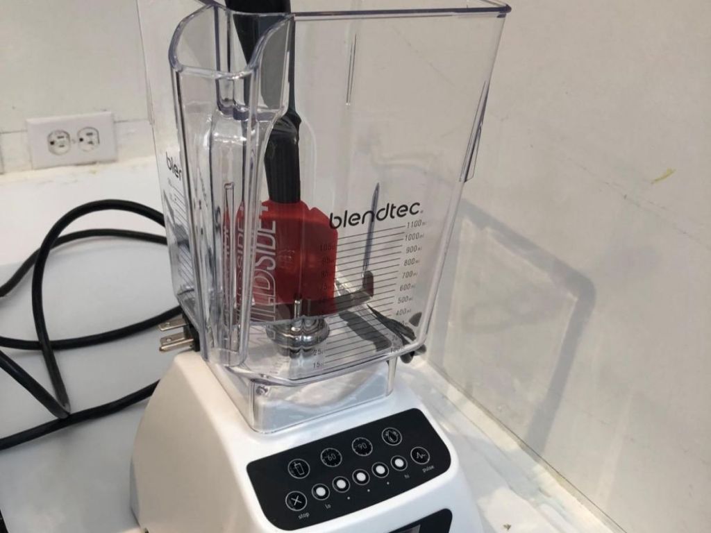 white blendtec blender and red spatula