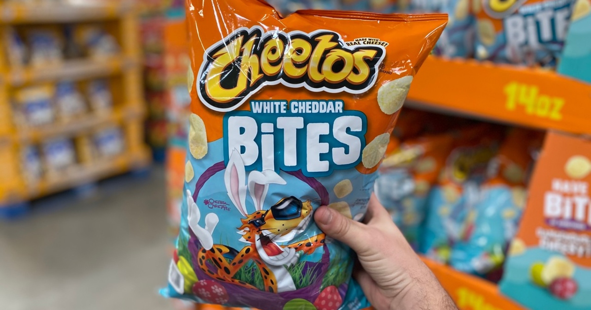 holding a bag of Cheetos White Cheddar bites