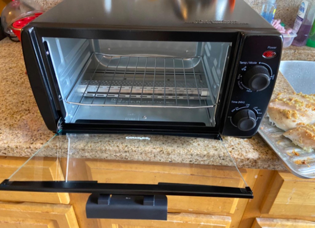 close up of open black toaster oven on kitchen counter