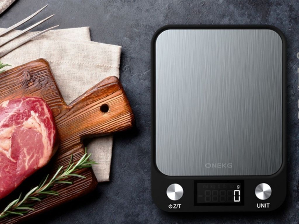 digital scale with cutting board and slab of meat next to it