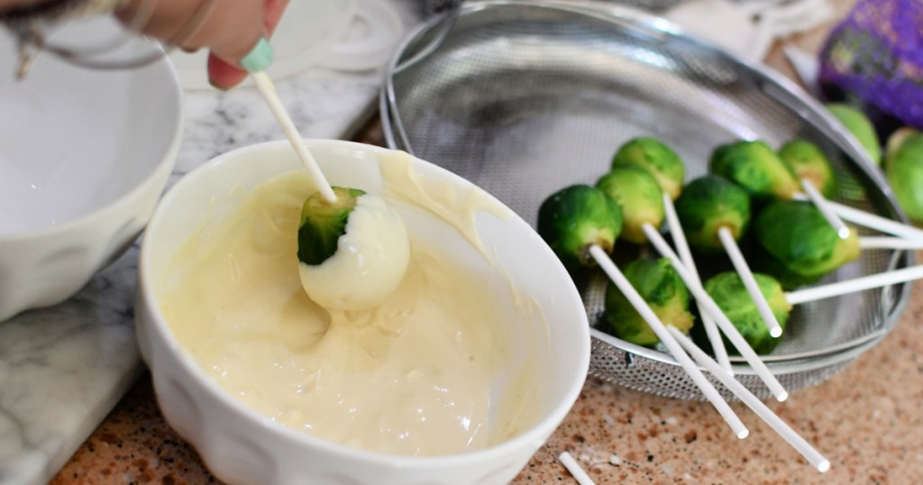 dipping Brussels sprouts in melted candy melts