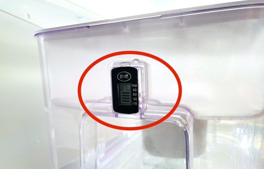 close up of water filter dispenser with red circle on countdown