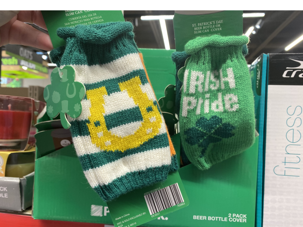 hand holding green knitted bottle covers in store