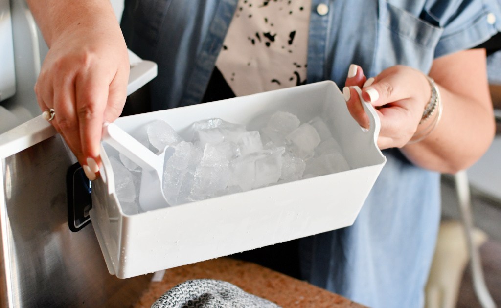 holding a tray of ice cubs from Euphomy ice maker