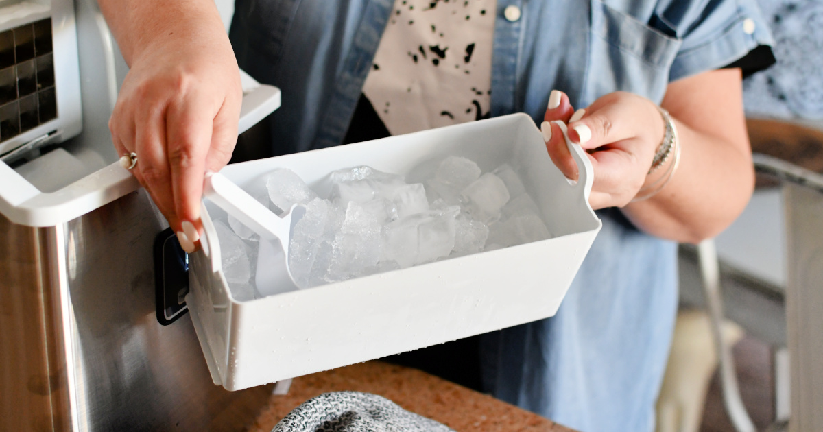 holding a tray of ice cubs from Euphomy ice maker