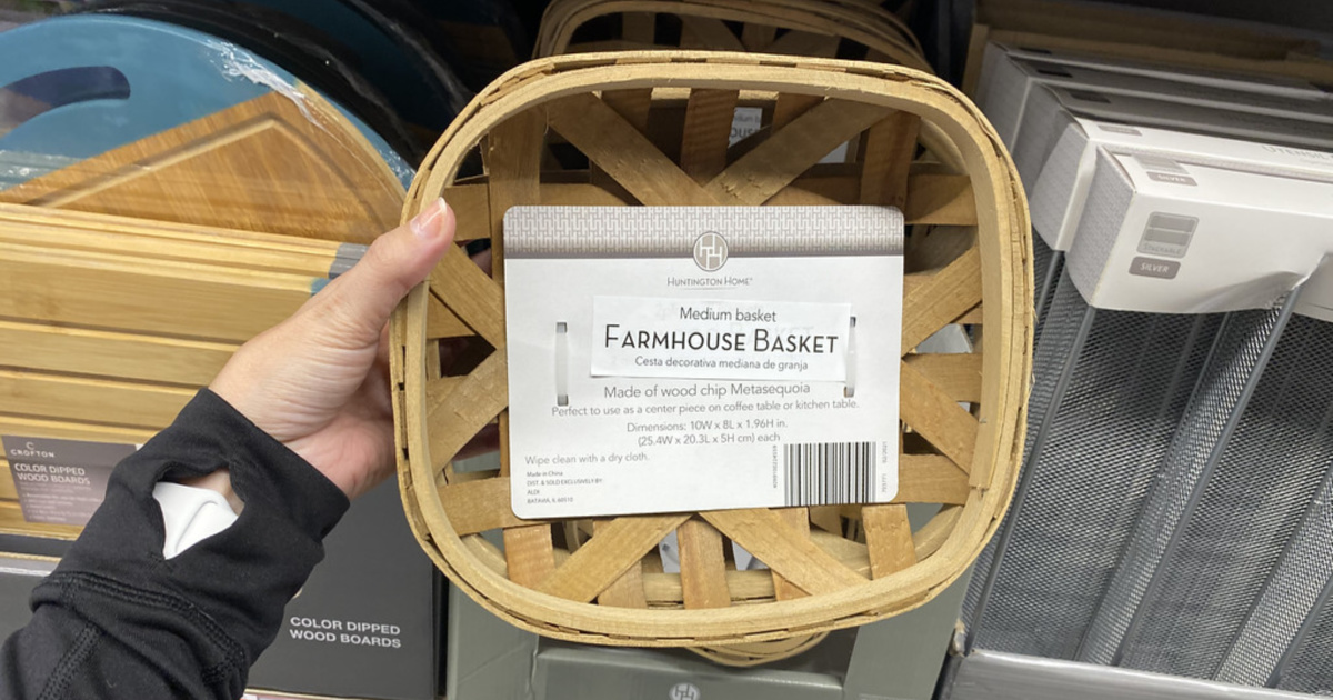 hand holding a farmhouse basket in front of a store shelf