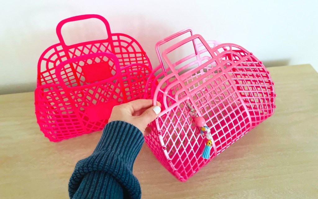 hand holding pink jelly basket with keychain