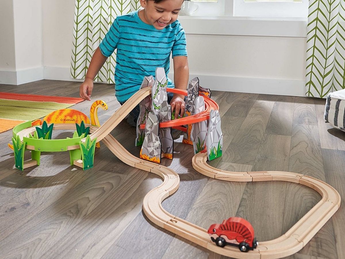 kid playing with race car set