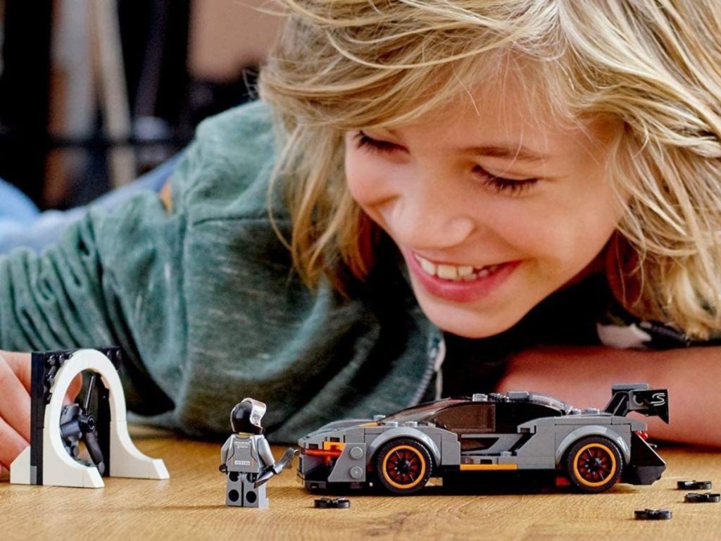 boy playing with lego car and figure
